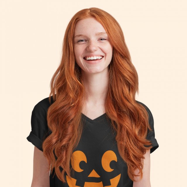 Woman wearing a fun Halloween T-shirt with a pumpkin on it.